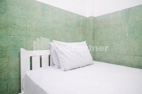 Кровать или кровати в номере Kostel Satu Semarang RedPartner