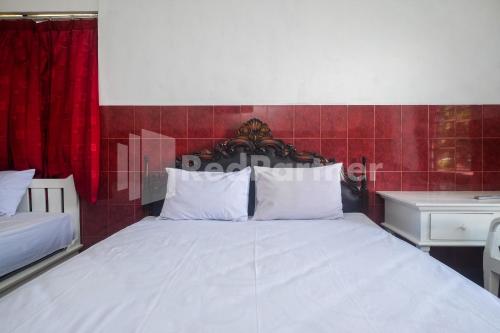 Кровать или кровати в номере Kostel Satu Semarang RedPartner