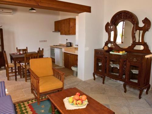 a kitchen and a living room with a table at Porfyrios Country House in Chirokitia