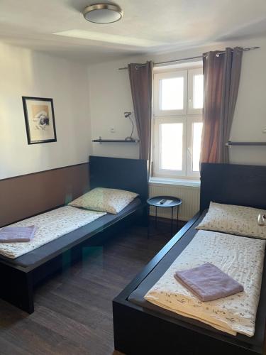 a room with two beds and a window at Hostel u Arény in Ostrava