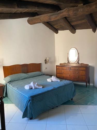 a bedroom with a bed with two towels on it at La Locanda del Curato Rooms in Lentiscosa