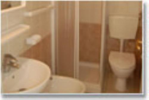 a bathroom with a toilet and a sink at Appartamenti Villa Miramare in Capoliveri