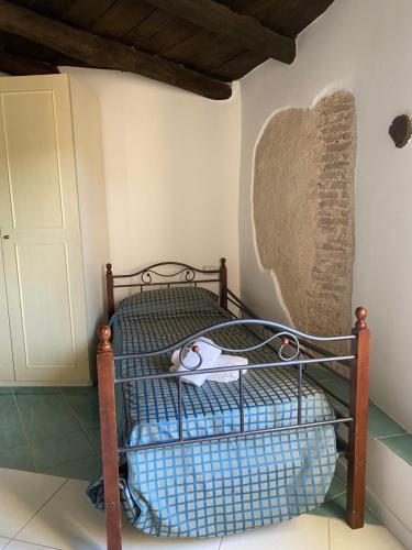 a small bed in a room with a wall at La Locanda del Curato Rooms in Lentiscosa