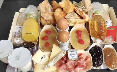 a tray of food with eggs and bread and pastries at L'Esplanade Lille in Lille