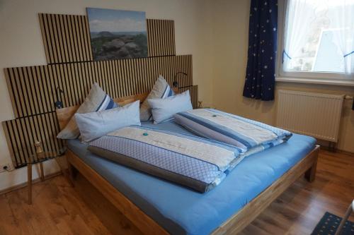 a bedroom with a bed with blue sheets and pillows at Ferienwohnung Familie Frank in Kurort Rathen