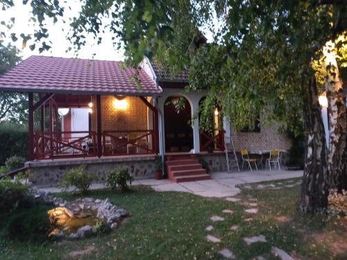 a house with a gazebo in the yard at Iriški san in Irig