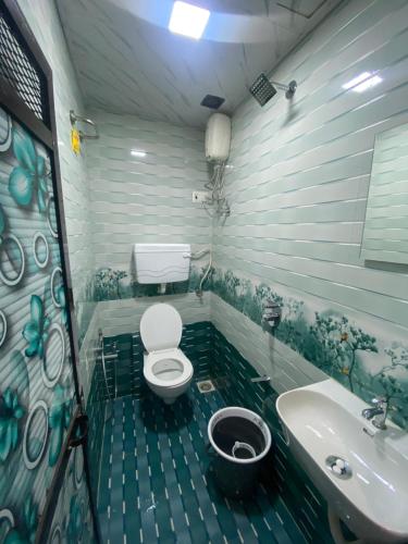 a bathroom with a toilet and a sink at Hotel Sai Residency in Mumbai