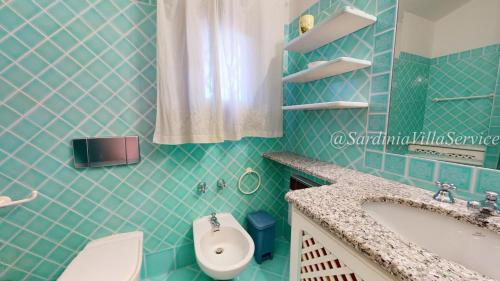 a bathroom with a sink and a toilet at Appartamento Dream - Cala Granu in Porto Cervo