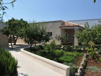 a house with a garden in front of it at Dimora Cavalieri charming house salento puglia in Andrano