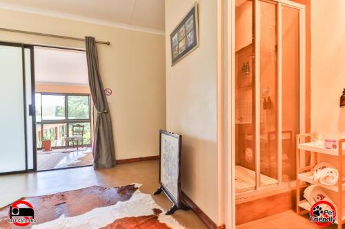 a living room with a mirror and a tv at Cinzaco Dullstroom in Dullstroom