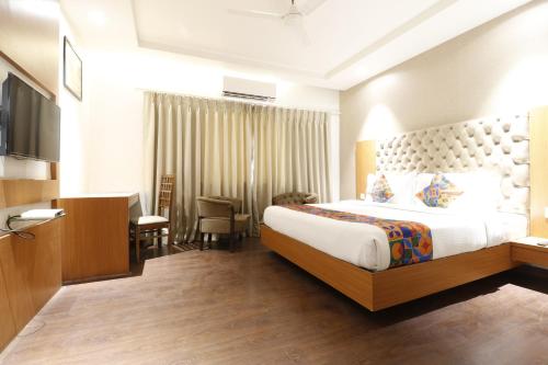 a hotel room with a large bed and a television at HOTEL YATRI in Nagpur