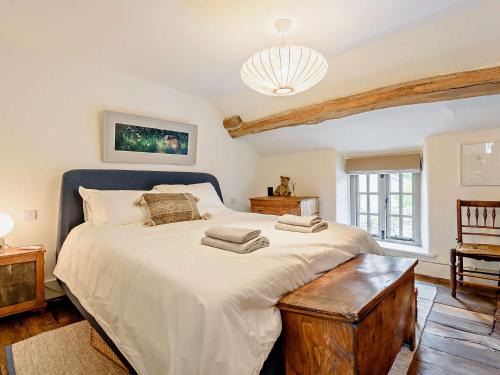 a bedroom with a large bed with a blue headboard at 2 Bed in Hay-on-Wye 93221 in Hay-on-Wye