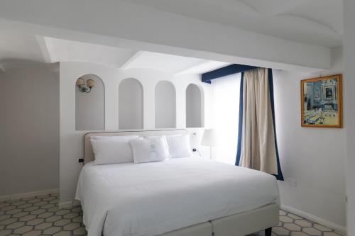 Postel nebo postele na pokoji v ubytování Grand Hotel Cocumella
