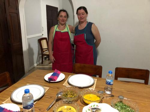 two women standing in front of a table with food at The Esence of Sri Lanka in Ahungalla