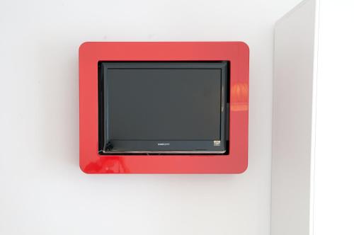 a red box with a screen on a white wall at Hotel Milan in Rosolina Mare