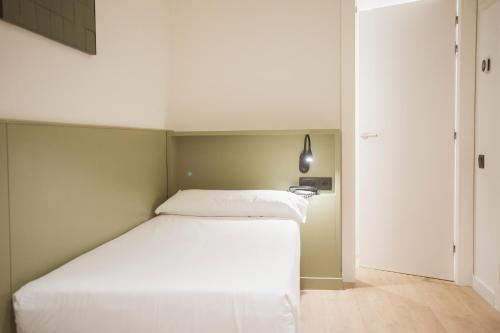 a bedroom with a white bed in a room at Hotel Sant Pau in Barcelona