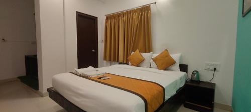 a bedroom with a large bed in a room at Hotel Dhruv Palace Bangalore Jakkur in Bengaluru