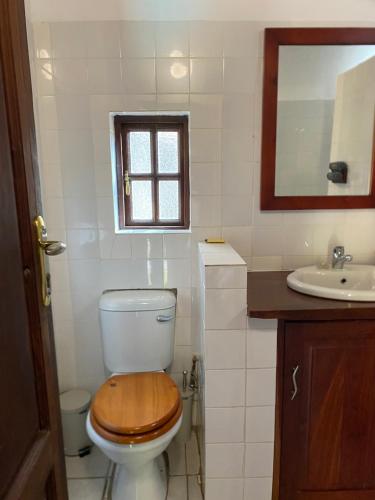 a bathroom with a toilet and a sink at The Little Outlook in Victoria Falls