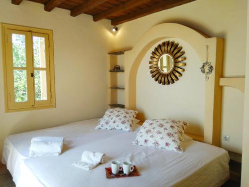 a bedroom with a bed with a mirror on the wall at Tinian View Bee Home Maisonette in Arnados