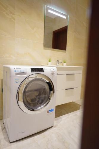 a washing machine in a bathroom with a sink at Apartment U Černého Orla in Karlovy Vary