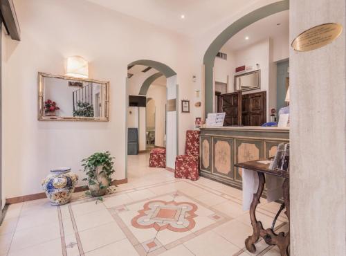 a large hallway with a counter and a table at Hotel Galileo in Florence