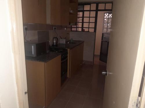 a kitchen with a stove and a microwave at great wall in Nairobi