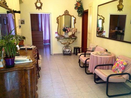 a room with chairs and a table and a mirror at HOTEL SARA in Turin