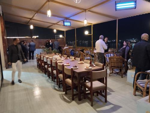 a group of people standing around a long table at Merryland Hotel Luxor in Luxor
