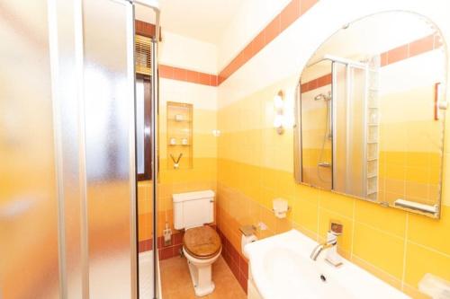 a bathroom with a toilet and a sink and a shower at Soul Etxia in Bermeo