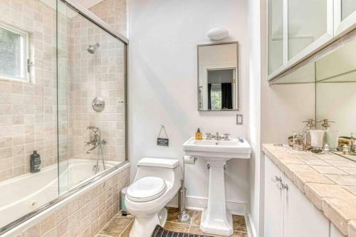a bathroom with a toilet and a sink and a shower at Share a bathroom for a fee in East Hampton