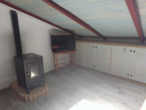 uma sala de estar com lareira e televisão em CASA CARMELA em Higuera de la Sierra