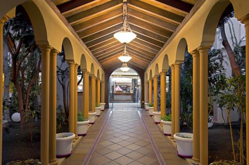 a hallway with columns and a ceiling with a light fixture at Elba Lucía Sport & Suite Hotel in Costa de Antigua