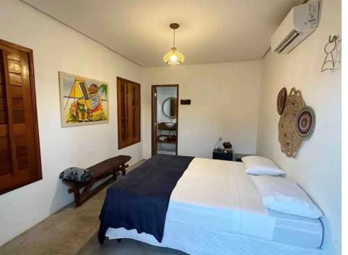 a bedroom with a large bed in a room at Casa Branca BG in Barra Grande