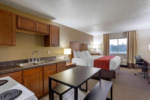 a large hotel room with a bed and a kitchen at Comfort Inn Hobart - Merrillville in Merrillville