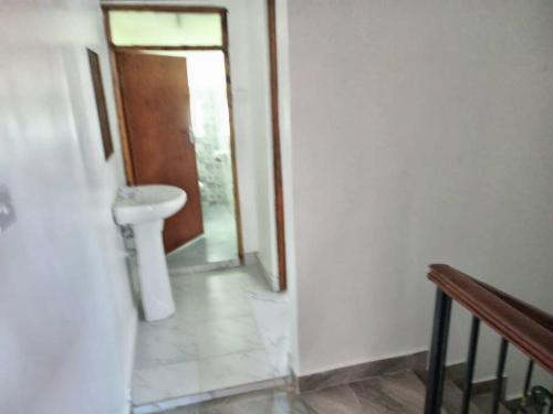 a bathroom with a sink and a toilet at Storm Executive in Kilifi