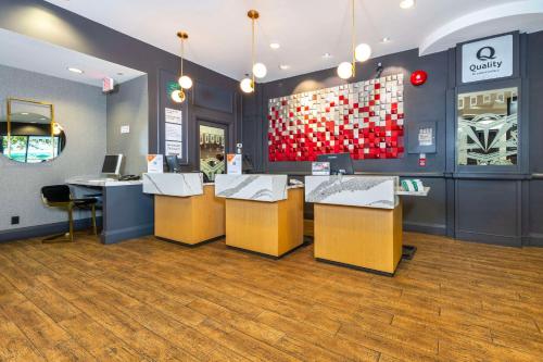 a restaurant with a counter with chairs and tables at Quality Inn & Suites in Vancouver