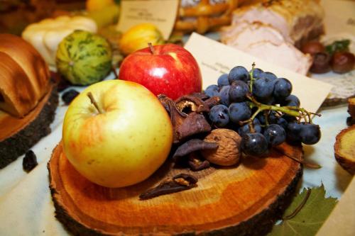 an apple and other fruits and vegetables on a table at Terme Zreče – Vile Terme Zreče in Zreče