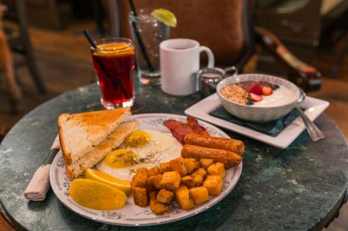 a plate of breakfast food with eggs bacon and toast at Quality Inn & Suites in Vancouver