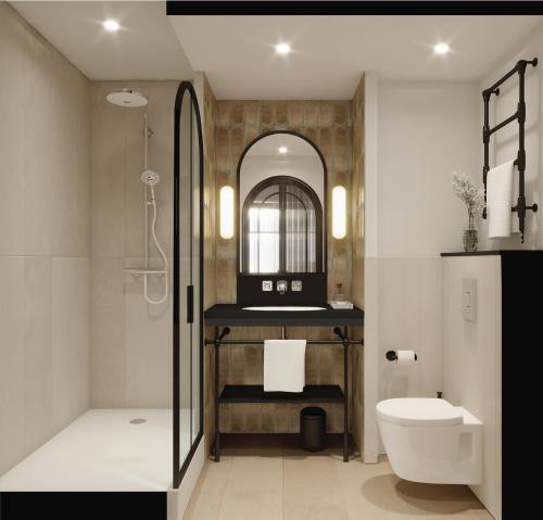 a bathroom with a shower and a toilet and a sink at Hotel Grand Coeur Latin in Paris