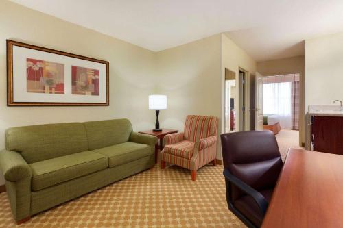 a living room with a couch and a chair at Garner Hotel Gillette South by IHG in Gillette
