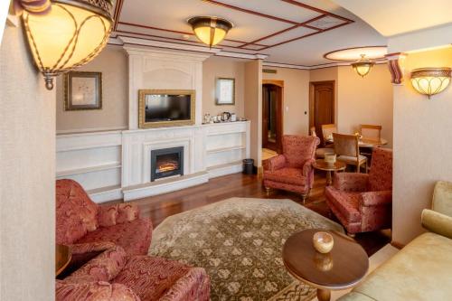a living room with a couch and a fireplace at The Central Palace Taksim in Istanbul