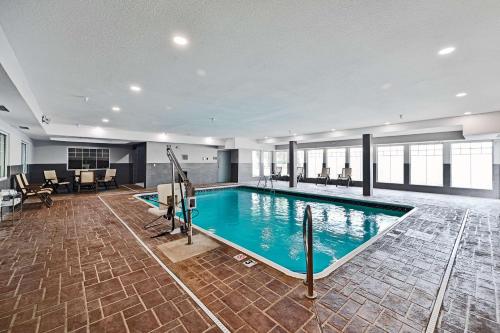 a large swimming pool in a building at Country Inn & Suites by Radisson, Bloomington-Normal Airport, IL in Bloomington