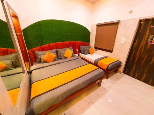 a bedroom with a bed with a green headboard at The Vacation Villa in Agra