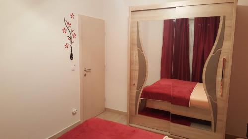 a bedroom with a mirror with a bed in it at Apartment Orloj in Primo&scaron;ten