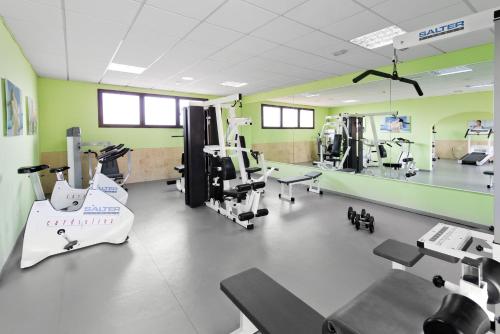 a gym with treadmills and machines in a room at Elba Lucía Sport & Suite Hotel in Costa de Antigua