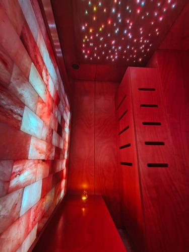 a red corridor with a red ceiling with lights at Fantastica Casa Poppo in Bellano