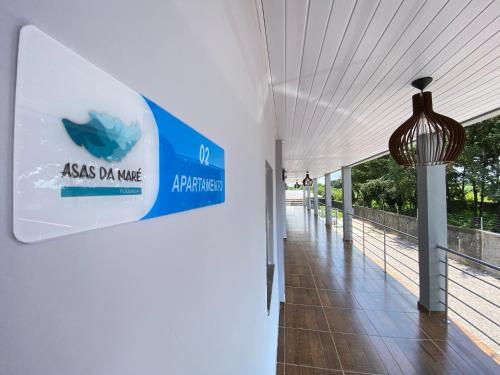 a hallway of a building with a sign on the wall at Asas da Maré Pousada in Bragança