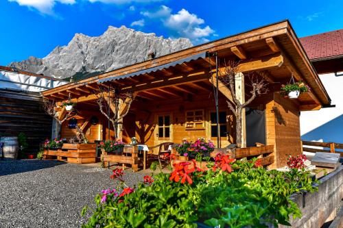 a log cabin with a mountain in the background at Haus Tirol Ehrwald in Ehrwald