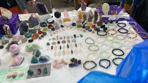 a table filled with lots of different types of gemstones at Sabrina Airport in Fiumicino