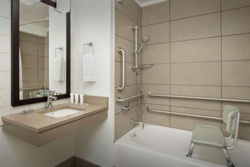 a bathroom with a sink and a toilet and a bath tub at Country Inn & Suites by Radisson, Seattle-Tacoma International Airport, WA in SeaTac